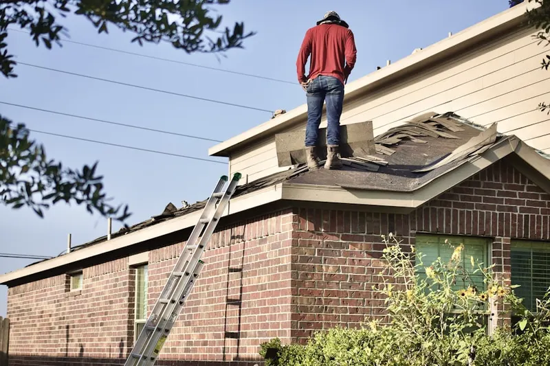 Professional roofer working on a residential roof in Seventh Day Adventist Village